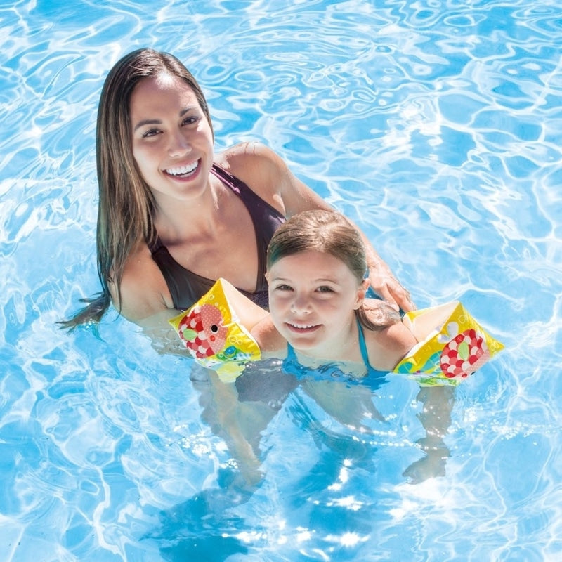children swimming arm floats